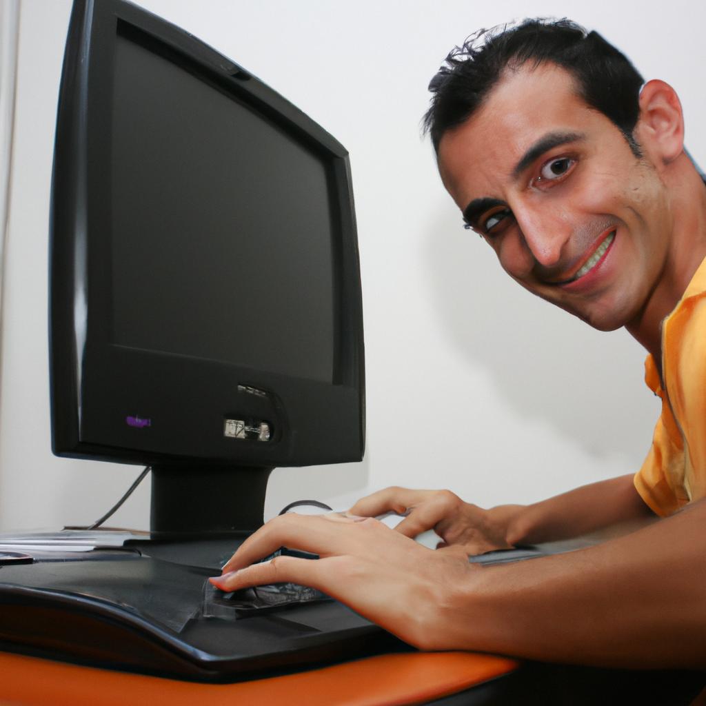 Person using a computer, smiling